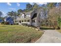 Beautiful home showcasing a spacious yard and long driveway, perfect for outdoor activities and gatherings at 928 Gate Post Ln, Lawrenceville, GA 30044