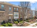 Lovely townhome exterior with brick facade, bay window, and landscaped front yard at , Duluth, GA 30096