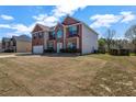 An exterior view of the home with a large lawn and an attached two-car garage at 4970 Wewatta Sw St, Atlanta, GA 30331