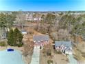 Stunning aerial view of the homes in a quiet residential neighborhood surrounded by mature trees at 1484 Highland Bluff Ct, Suwanee, GA 30024