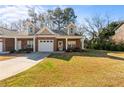 Attractive brick home with a two car garage and well-maintained lawn at 230 Rosenwald Ln, Hampton, GA 30228