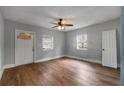 Bright bedroom with new hardwood floors, neutral walls, ceiling fan, and two windows for natural light at 1090 Harwell Nw St, Atlanta, GA 30314