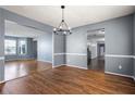 Open-concept dining room with hardwood floors, gray walls, chandelier and seamless connection to other spaces at 1979 Resting Creek Dr, Decatur, GA 30035
