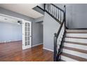 Welcoming entryway featuring hardwood floors, staircase with dark wood railing and gray walls at 1979 Resting Creek Dr, Decatur, GA 30035