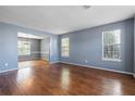 Bright living room with hardwood floors, two windows and gray walls at 1979 Resting Creek Dr, Decatur, GA 30035
