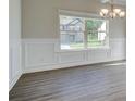 Bright dining room with wainscoting and view of exterior landscape at 212 Eleanora Way, Loganville, GA 30052