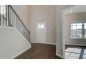 Bright entryway with hardwood floors and staircase leading to upper level at 212 Eleanora Way, Loganville, GA 30052
