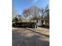 Back view of a single story home showing a driveway and carport at 1027 N Born Rd, Stone Mountain, GA 30088