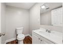 Neat, well-lit half-bath featuring tile floor, toilet, and vanity with sink at 3480 Hogan Sw Rd, Atlanta, GA 30331