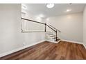 Inviting living room featuring wood flooring, natural light, and staircase at 3480 Hogan Sw Rd, Atlanta, GA 30331