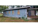 Side exterior of a house with peeling paint and boarded windows needing work at 868 Oakhill Sw Ave, Atlanta, GA 30310