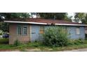 Side exterior of a house with peeling paint and boarded windows needing repairs at 868 Oakhill Sw Ave, Atlanta, GA 30310