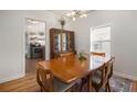 Classic dining room featuring hardwood floors, a china cabinet, and a view into the kitchen at 1810 S Gordon Sw St, Atlanta, GA 30310