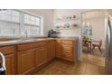 Bright kitchen with wood cabinets, stainless steel sink and view of the dining room at 1810 S Gordon Sw St, Atlanta, GA 30310