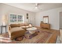 Bright living room with a tan sofa, white walls, and a large oriental rug on wood floors at 1810 S Gordon Sw St, Atlanta, GA 30310