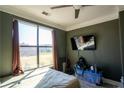 Bedroom with dark walls and a window that brings in natural light and features a ceiling fan at 401 16Th Nw St # 1463, Atlanta, GA 30363