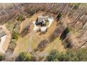 Aerial view of a home showcasing a circular driveway and a large, wooded lot at 4740 Union Hill Rd, Canton, GA 30115