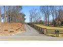 Long driveway leading to a beautiful property, surrounded by a well-maintained fence at 4740 Union Hill Rd, Canton, GA 30115