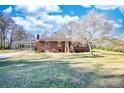 Brick home with a cozy entrance, enhanced by a covered carport, under a beautiful sky at 1715 Highway 11 N, Social Circle, GA 30025