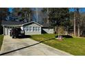 Charming home featuring a well-manicured lawn, light-colored siding, and a newly installed roof at 1655 Cherry Hill Sw Rd, Conyers, GA 30094