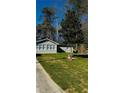 Charming home featuring a well-manicured lawn, light-colored siding, and a newly installed roof at 1655 Cherry Hill Sw Rd, Conyers, GA 30094