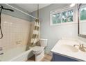 Cozy bathroom with tub and shower combination, plus a vanity with a sink and storage space at 2415 Wales Dr, Austell, GA 30106