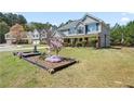 View of a house with a well-kept lawn and attractive landscaping features at 63 Shadowhill Ct, Loganville, GA 30052