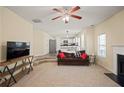Open-concept living room with neutral tones, a cozy fireplace, and a staircase at 63 Shadowhill Ct, Loganville, GA 30052