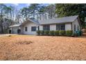 Single-story home with an attached garage and front yard bushes at 1463 Rockmoor Ct, Stone Mountain, GA 30088