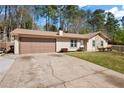 Charming single-story home with a well-manicured lawn, stone accents, and an attached two-car garage at 3776 Bromolow Trl, Lawrenceville, GA 30044