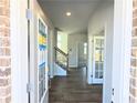 Welcoming foyer with wood-look flooring and staircase, leading to other parts of the home at 2664 Mourning Dove Drive( Lot 38), Grayson, GA 30017