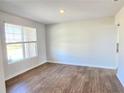 Inviting living room with wood-look floors and a view of the outdoors through a large window at 2664 Mourning Dove Drive( Lot 38), Grayson, GA 30017