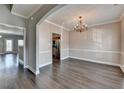 A view of the dining room featuring hard wood floors, a chandelier, and neutral-colored walls at 657 Kenridge Dr, Suwanee, GA 30024