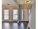 A view of the entryway featuring hard wood floors, natural light, and neutral-colored walls at 657 Kenridge Dr, Suwanee, GA 30024