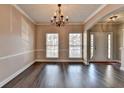 A view of the entryway featuring hard wood floors, natural light, and neutral-colored walls at 657 Kenridge Dr, Suwanee, GA 30024