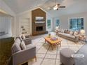 Bright living room boasts a brick fireplace, vaulted ceilings and natural light at 121 Northwoods Rd, Sharpsburg, GA 30277