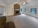 Bright living room featuring a brick fireplace and vaulted ceilings at 121 Northwoods Rd, Sharpsburg, GA 30277