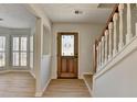Inviting entryway features wood floors, stairs, and stylish front door with decorative glass at 4654 Webster Way, Acworth, GA 30101