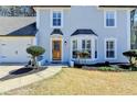 Close up of the light blue home's decorative wooden front door and bay window with white trim at 4654 Webster Way, Acworth, GA 30101