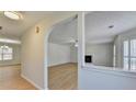 Bright living room featuring an archway, fireplace, and wood-look flooring at 4654 Webster Way, Acworth, GA 30101