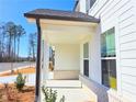 Covered porch with brick accents, recessed lighting, and space for outdoor seating at 2714 Mourning Dove Drive (33), Grayson, GA 30017