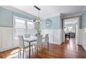 Elegant dining room with hardwood floors, wainscoting, and large windows at 415 Fayetteville Rd, Decatur, GA 30030