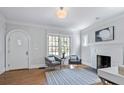 Cozy living room with fireplace, hardwood floors, arched door and bright windows at 415 Fayetteville Rd, Decatur, GA 30030