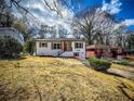 Charming renovated home with a welcoming red door and stylish wood shutters, set on a spacious lot at 1238 Westboro Sw Dr, Atlanta, GA 30310