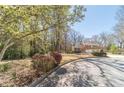 Charming curb view of a yellow two-story home with a well-manicured lawn and mature trees at 45 Somerset Ct, Covington, GA 30016