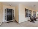 Inviting front porch with decorative columns and ample seating with mature shrubbery at 775 Freeman Dr, Covington, GA 30016