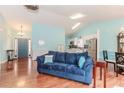 Sun-filled living room featuring hardwood floors, modern lighting and neutral paint palette at 775 Freeman Dr, Covington, GA 30016