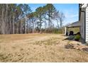 Sprawling backyard featuring an expansive lawn and covered patio, ideal for outdoor activities and relaxation at 844 Pool Rd, Hiram, GA 30141