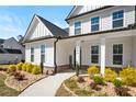 Inviting entrance with a 'WELCOME' sign, manicured shrubs, and a brick-lined walkway, enhancing curb appeal at 844 Pool Rd, Hiram, GA 30141