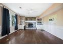 Living room with a stone fireplace, built-in bookshelves, and hardwood floors at 985 Lake Haven Ct, Roswell, GA 30076